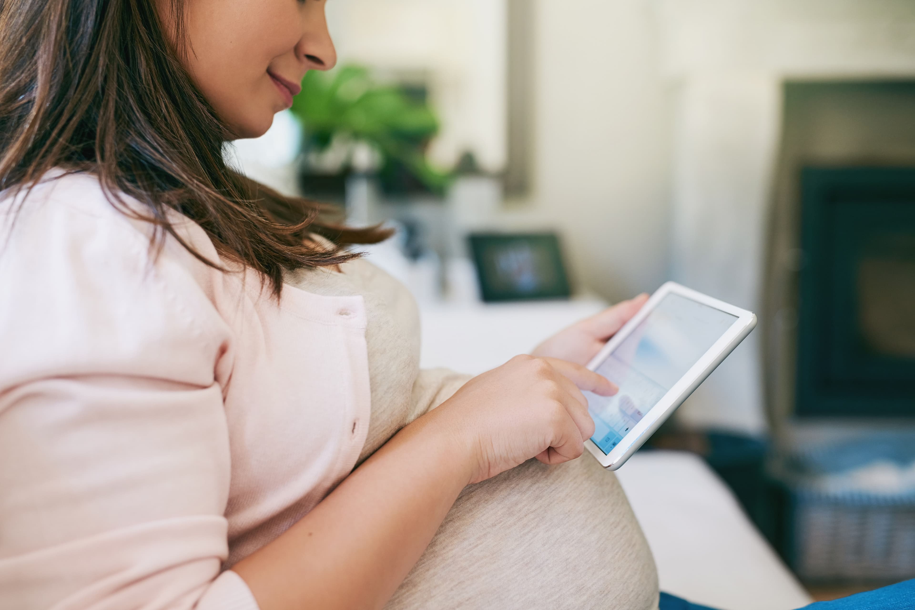 Pregnant woman utilizing telehealth services / peopleimages.com - stock.adobe.com