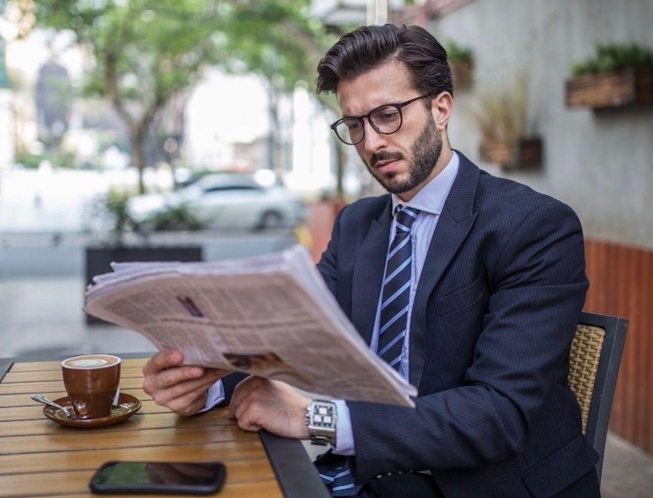 man reading newspaper 