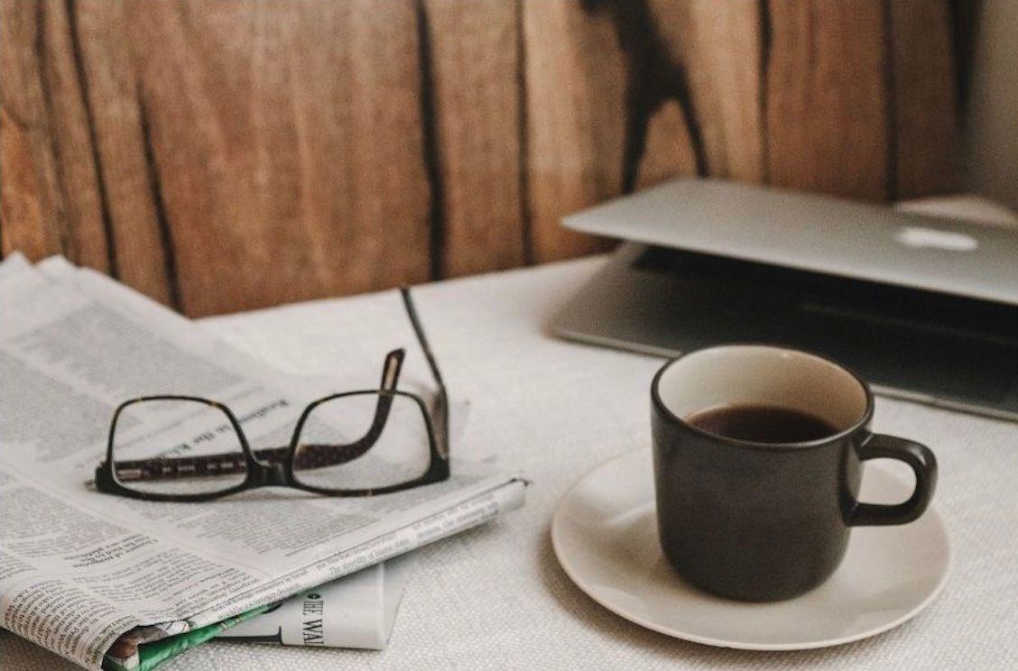 newspaper and coffee cup