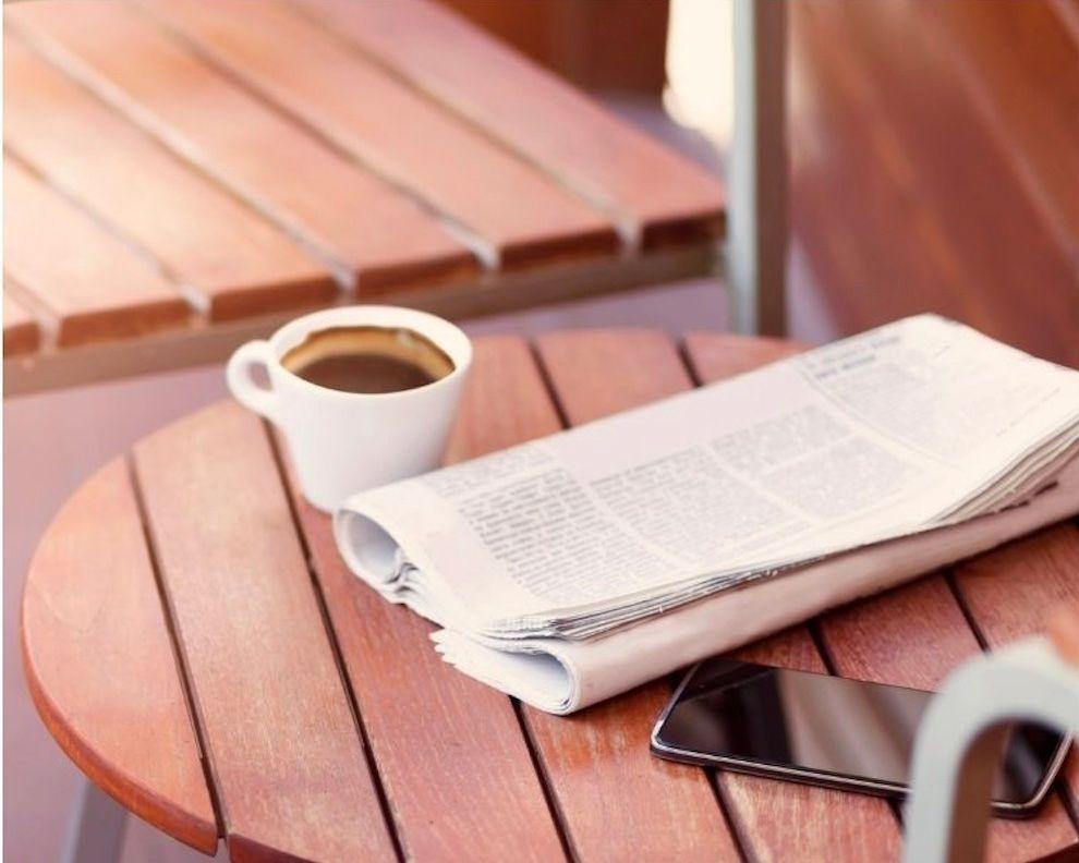 newspaper and phone on table